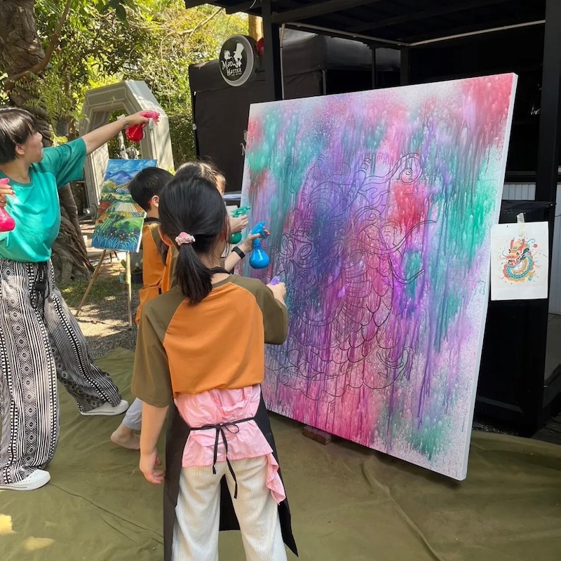 Kids painting a mural in an art class